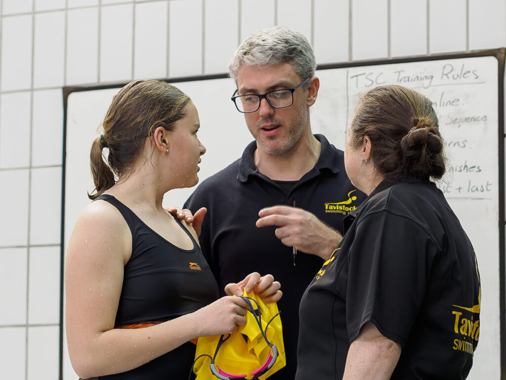 James Lake talking to a swimmer and her mother