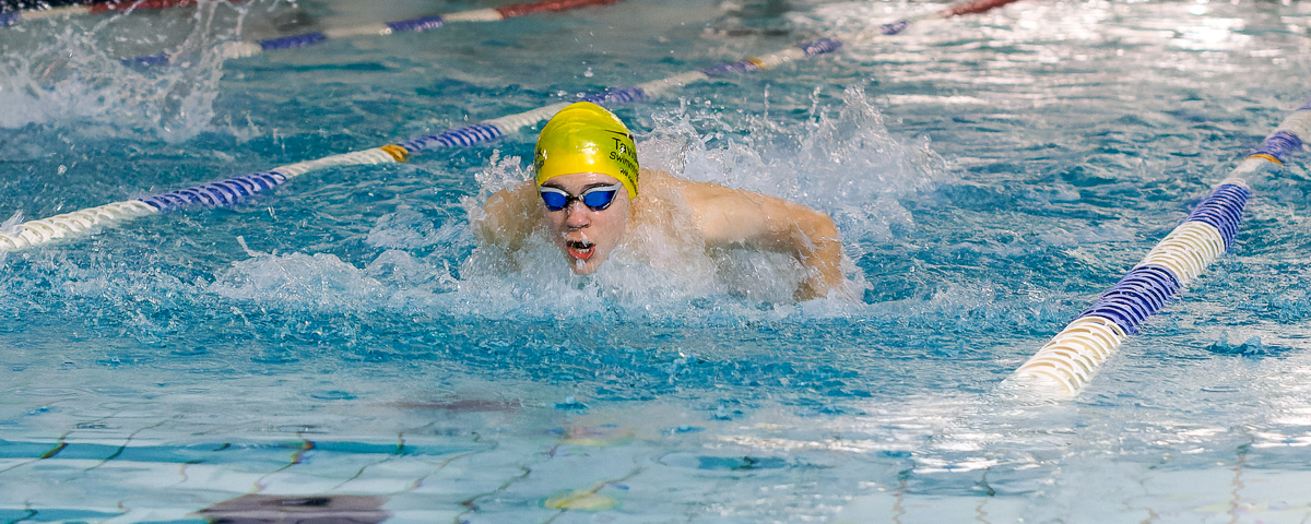 male swimming doing butterfly